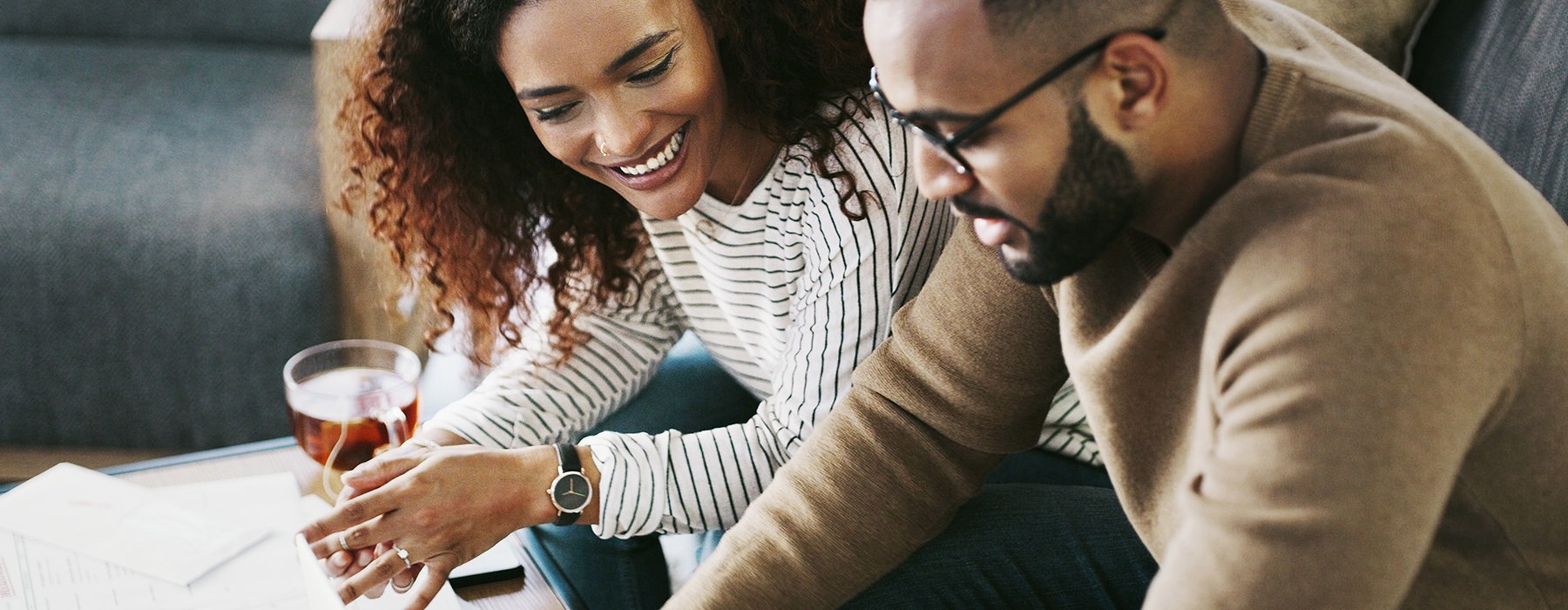 Two people looking at a laptop while contacting Abode at Geneva about rental homes in Fuquay-Varina, NC.
